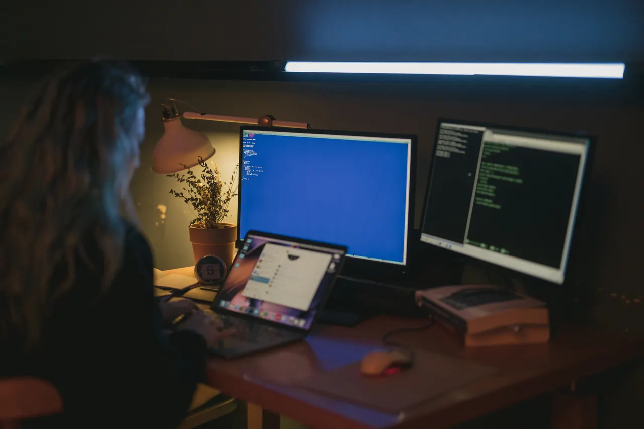 Operational security — a person working at a computer with multiple screens