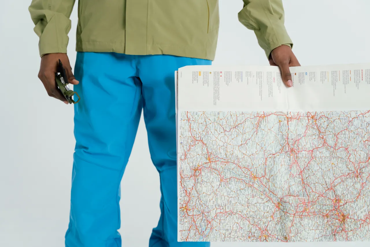Situational awareness — a person checking a map and compass outdoors